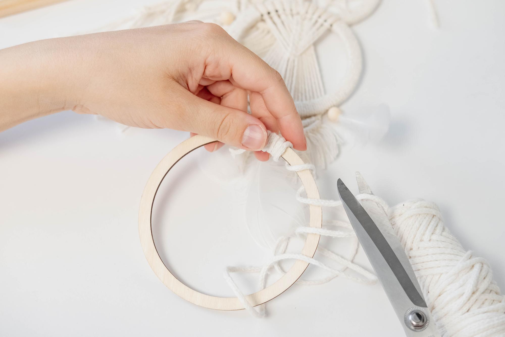 Artisan at work with hoop and threads