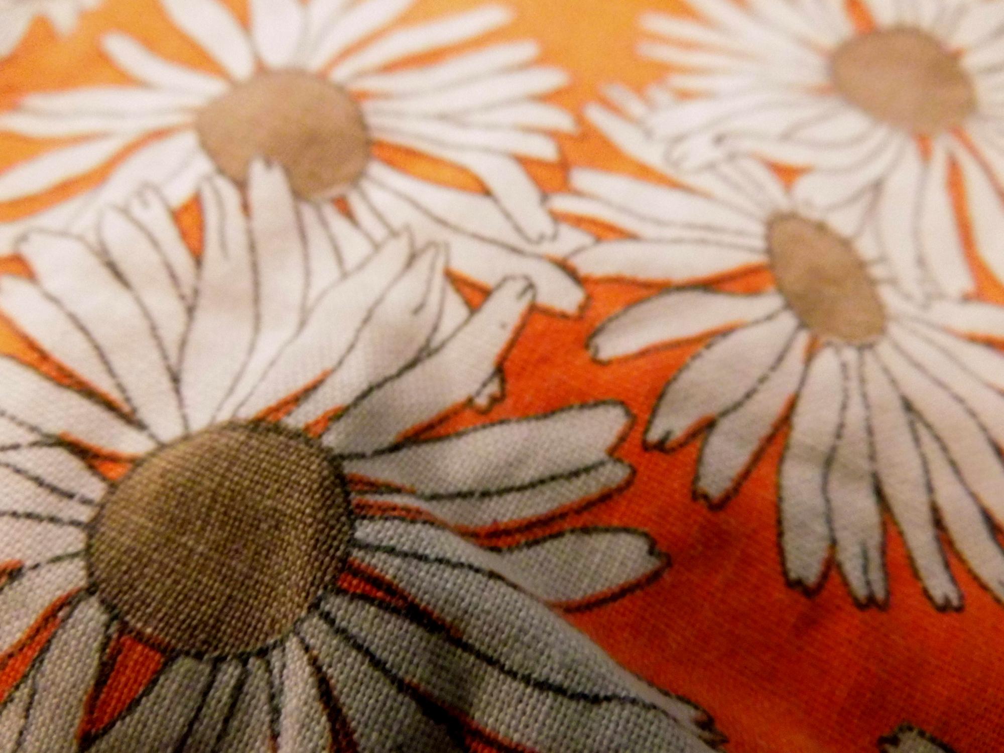 Close-up of embroidered floral motif on linen